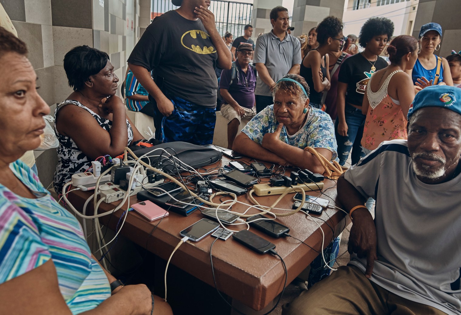 People charge their phones in San Juan, Puerto Rico, on Sept. 30, 2017.