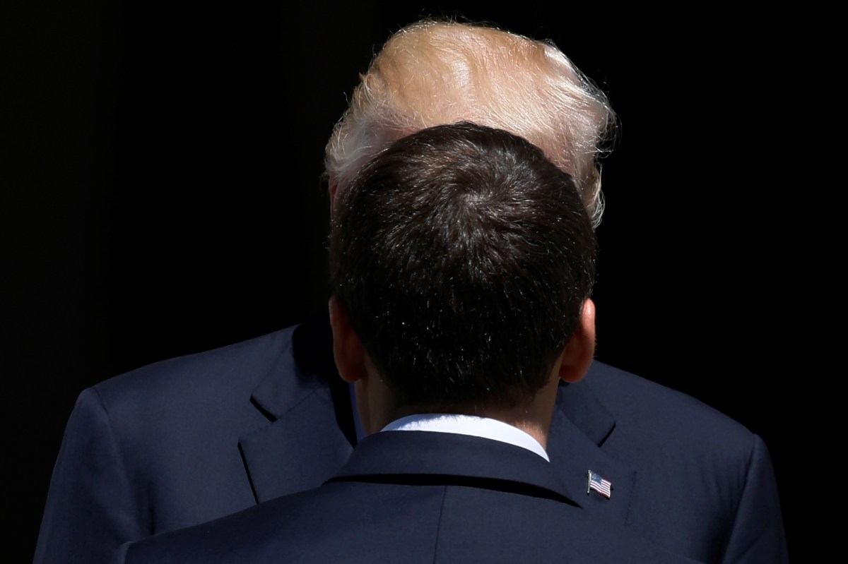 U.S. President Trump greets French President Macron before a lunch ahead of a NATO Summit in Brussels