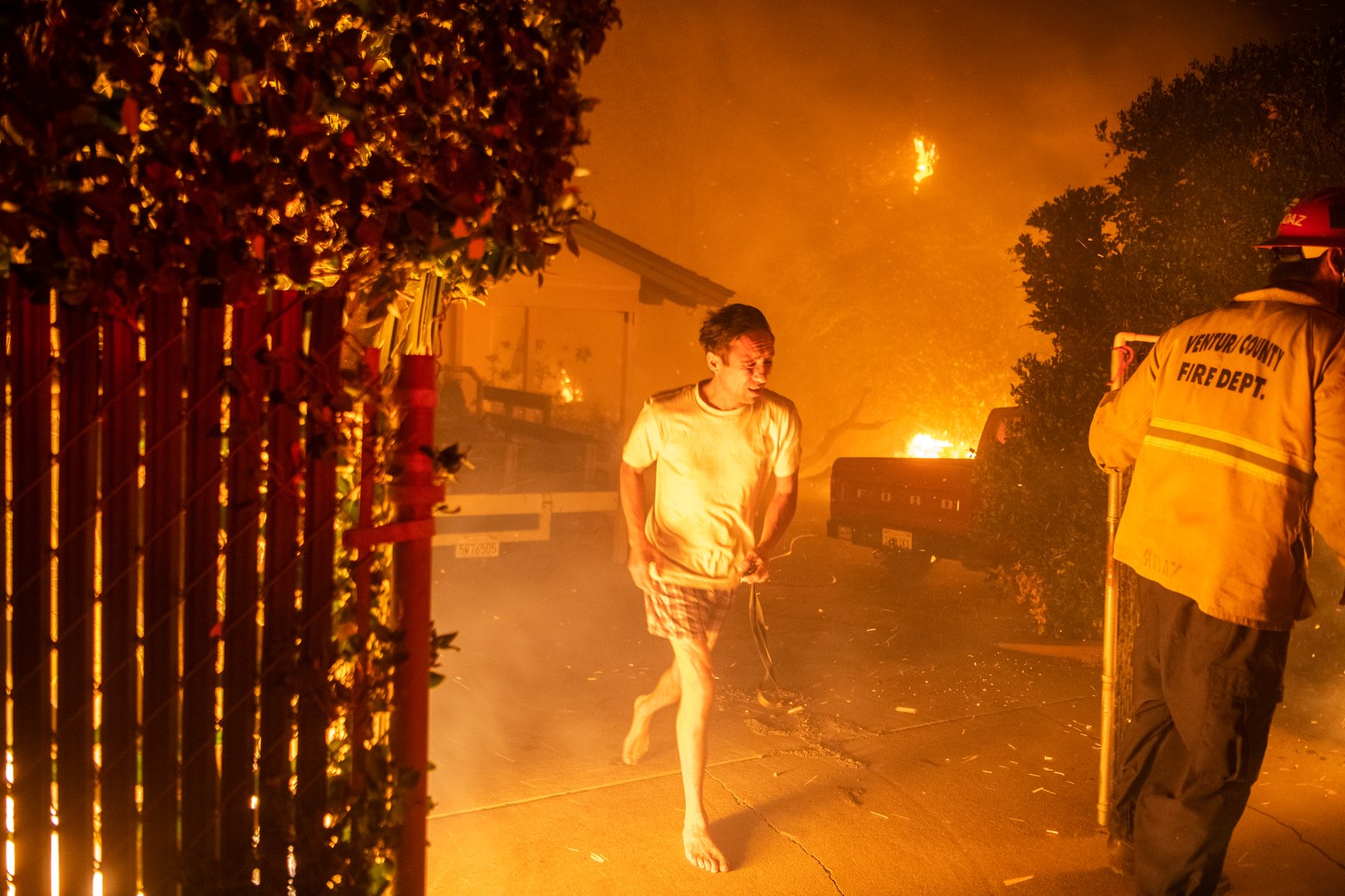 A resident flees his home in Thousand Oaks, Calif. during a wildfire
